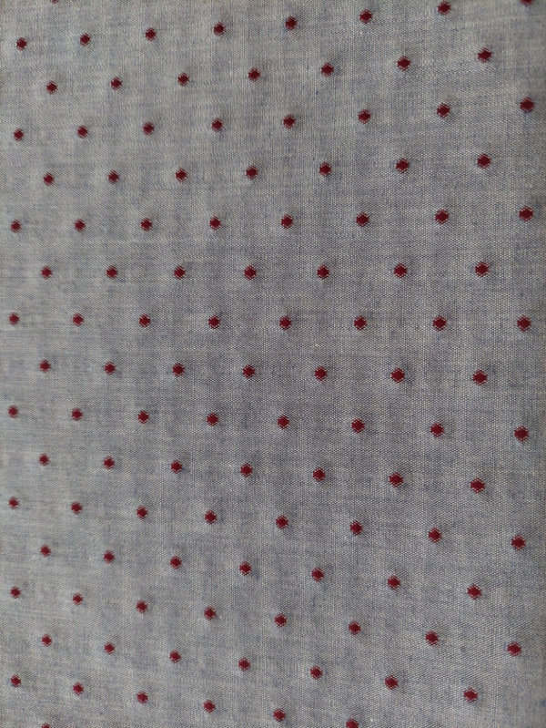 Baumwollstoff mit roten Punkten auf jeansfarbenem Hintergrund
